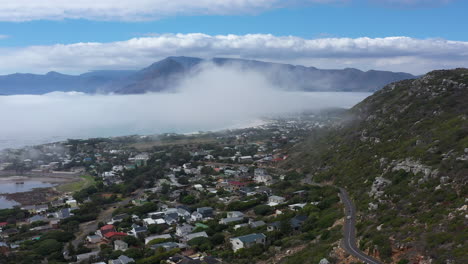 fog over a coastline city in south africa aerial sunny morning