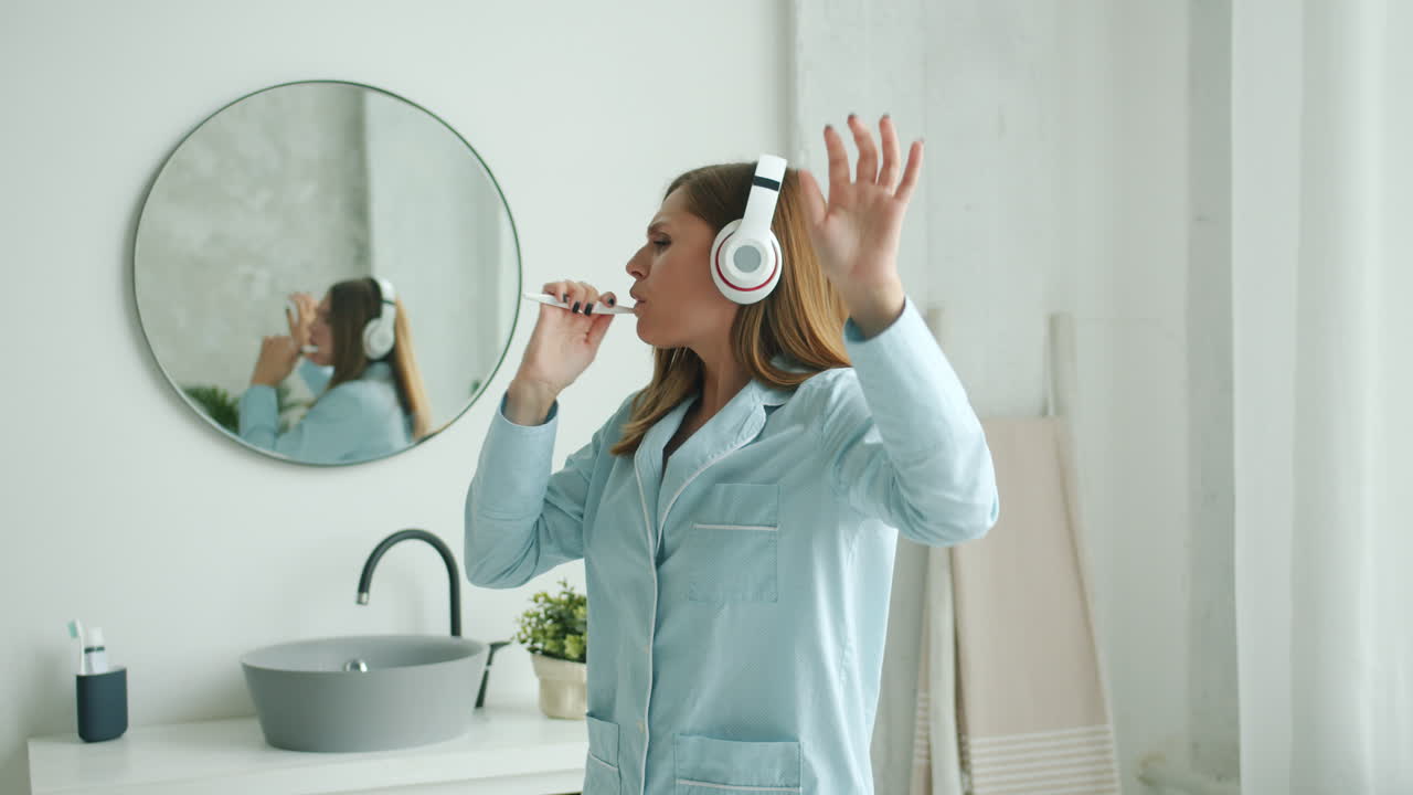 Woman Brushing Her Teeth and Dancing in Pajamas