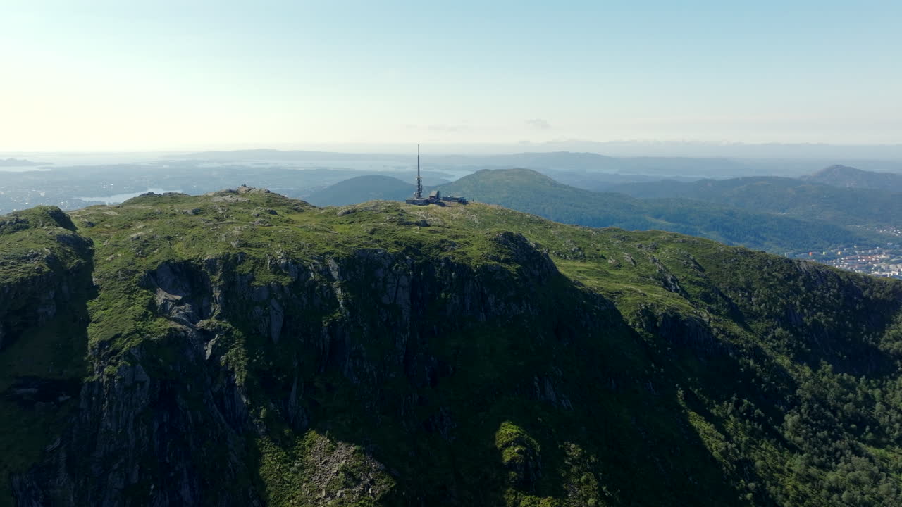 Vertical aerial climb over Ulriken, Norway, revealing the mountain’s summit and surrounding landscapes