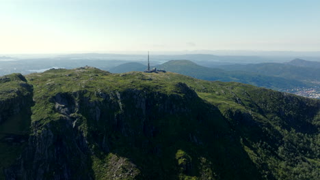 vertical aerial climb over ulriken, norway, revealing the mountain’s summit and surrounding landscapes