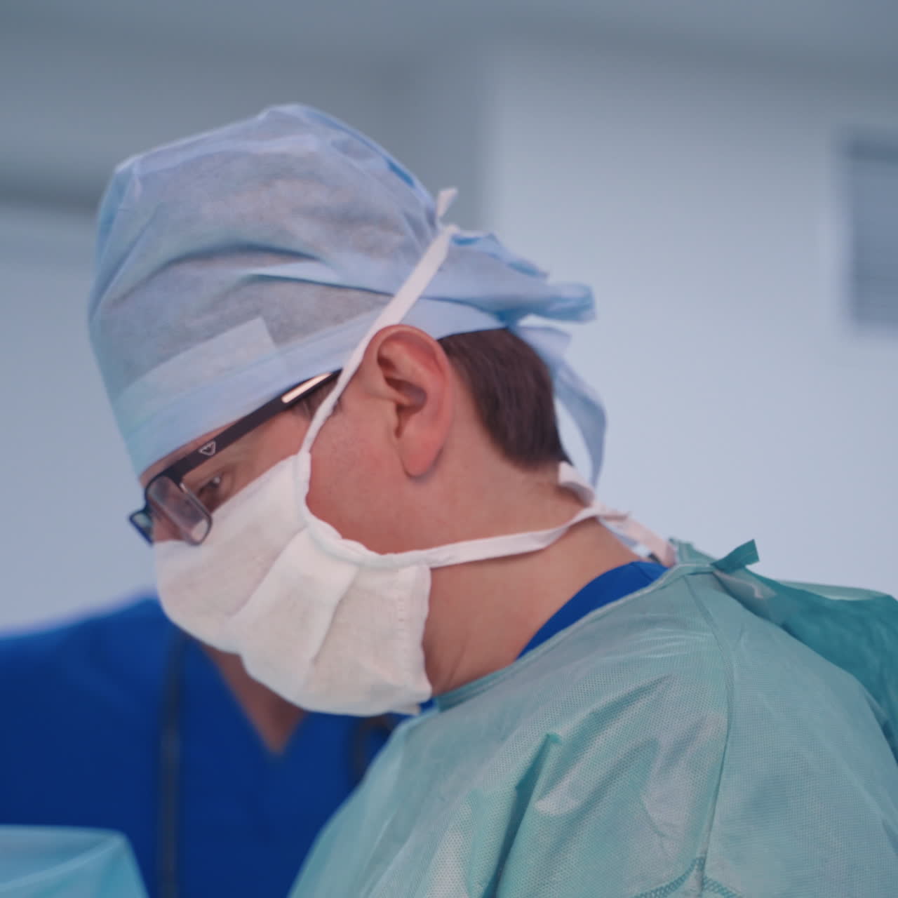 In the hospital operating room. Team of professional surgeons and nurses working in operating theatre.