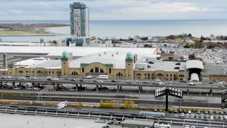 Aerial-view-zooming-in-on-the-Gardiner-Expressway,-Billy-Bishop-Airport-and-Lake-Ontario-in-Toronto