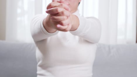 detail of woman performing hand stretching due to constant use of technologies