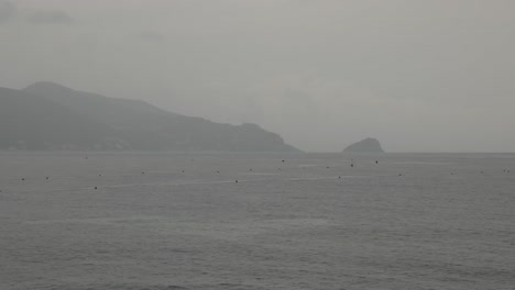 Rainy-Sea-Beach-Shore-Line-Waves-Distant-Island