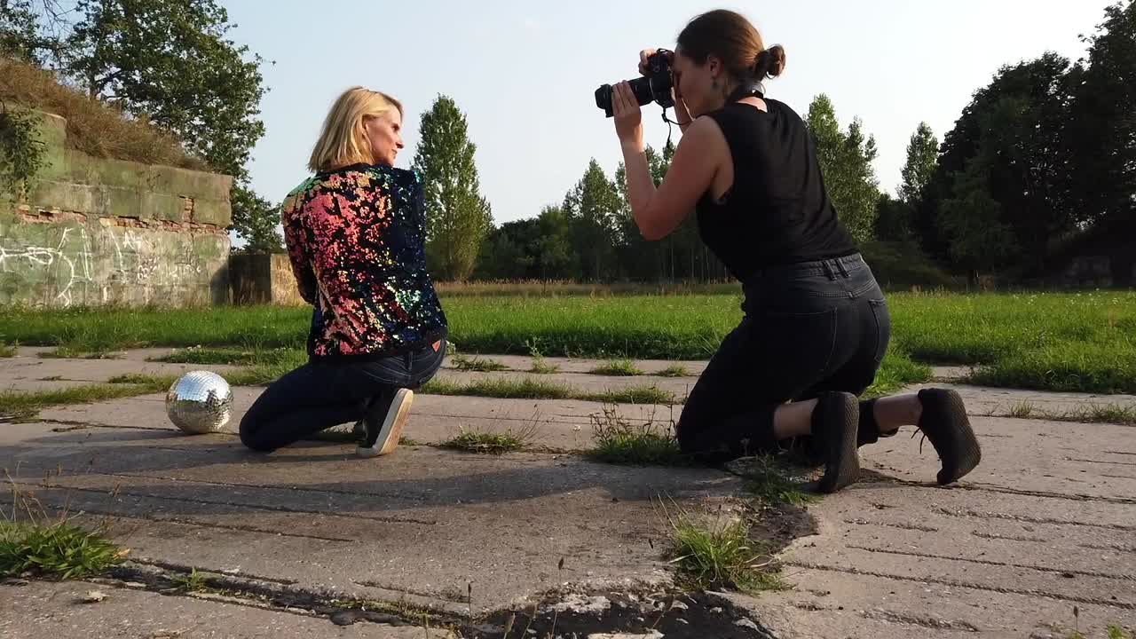 Gorgeous slow motion cinematic behind the scene shot on russion airfield with a professional model with blond hair and disco ball. Foto video shoot on lost places in nature 1080 24p by Philipp Marnitz