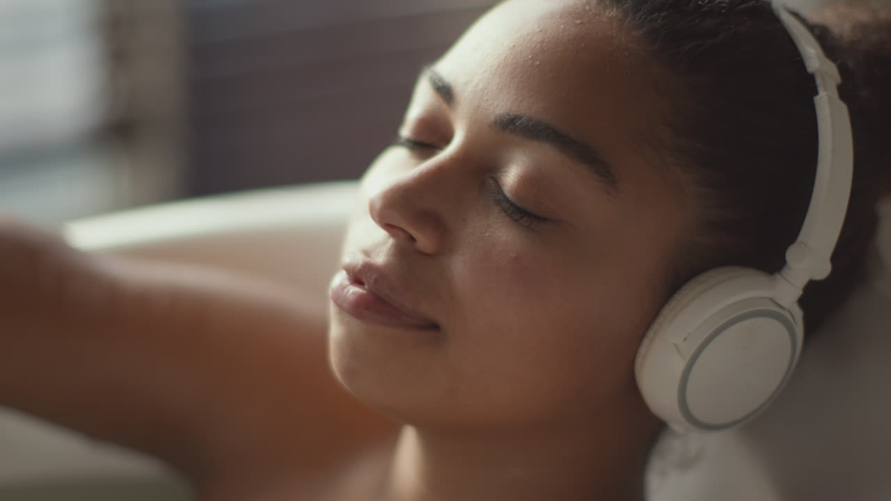 Woman Relaxing in a Bathtub with Headphones