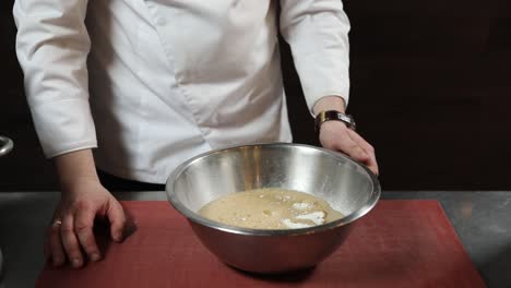 chef mixing ingredients for bread dough