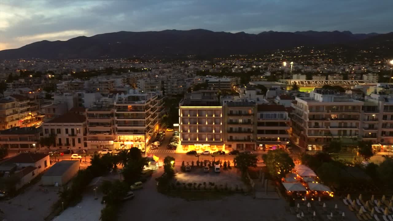 Aerial bird's eye view of Navarinou coastal road at Kalamata, Peloponnesus, Greece. Cloudy afternoon 4k