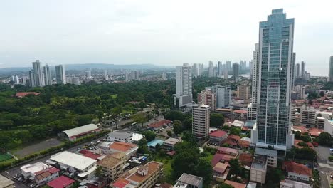 aerial drone footage contrast between the old residential area and the modern buildings city and a park in the middle in panama city