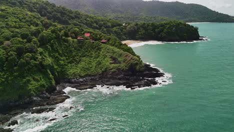 aerial drone footage moving inland from turquoise coastal waters at lanta, thailand