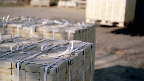 warehouse automatic truck is transporting pallets with bricks and folding its in one place on the territory of factory