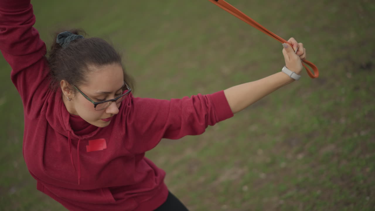 Confident Female Coach On Grass, Selfassured Woman Showcases Strength And Authority Outdoors, Dynamic Asian Woman In Athletic Stance Communicates Confidence And Inspiration In Open Park Setting