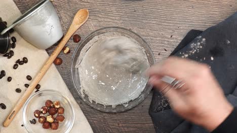a delicious dessert, coffee hazelnut cream tart. made with espresso powder, chocolate crust and loaded with crushed hazelnut. using a whisk to combine ingredients such as expresso powder and milk