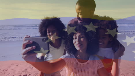 family taking selfie on beach with venezuela flag animation over them