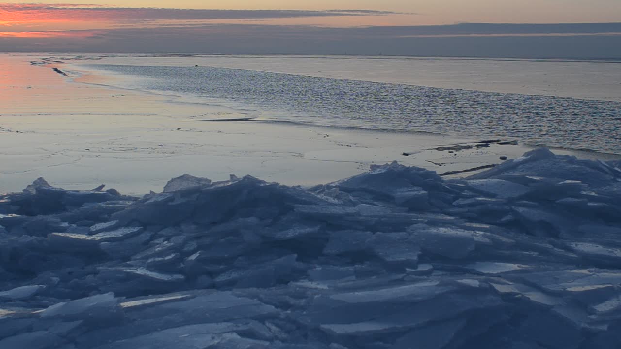 Uuden jään liike. Auringonlasku jäätymässä olevan meren yllä.