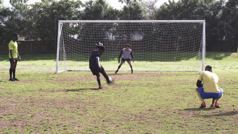 Soccer players celebrating goal with cartwheel on sunny field, showing excitement