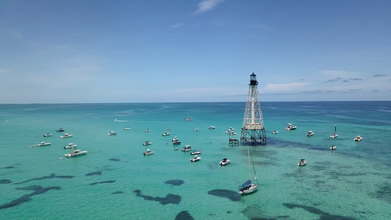 Drone footage of boats and Alligator Lighthouse in Atlantic Ocean off coats of Islamorada, Florida Keys. Shot on Mavic Pro in 4k.