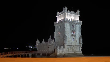 lit up belém tower from front view in the evening in lisbon, portugal