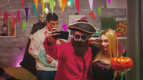 spooky bearded pirate taking a selfie with beautiful repear woman