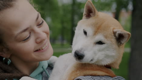 woman and shiba inu dog in park