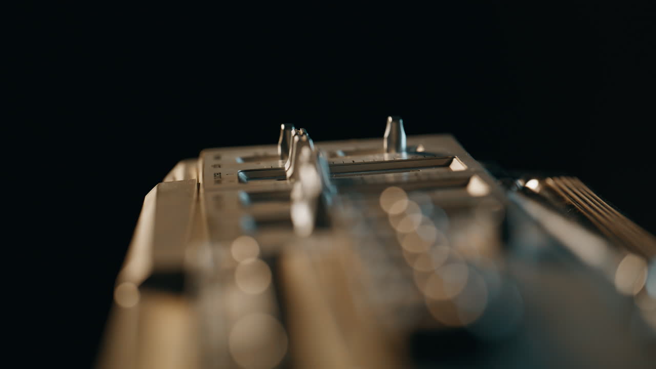 Macro vintage panel boombox in dark room. Closeup metal retro musical device