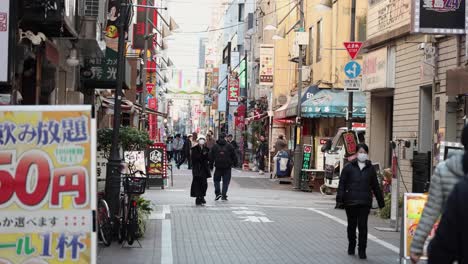 pedestrians walking down a busy urban street