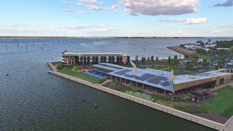 low aerial view turning around in the front of the sebel hotel over lake mulwala in yarrawonga