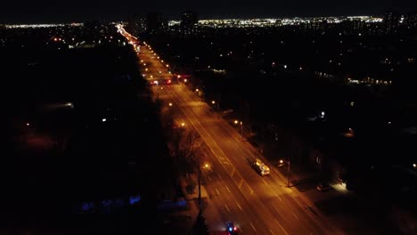 aerial view of fire truck responding to accident at the road intersection at night in toronto, ontario, canada