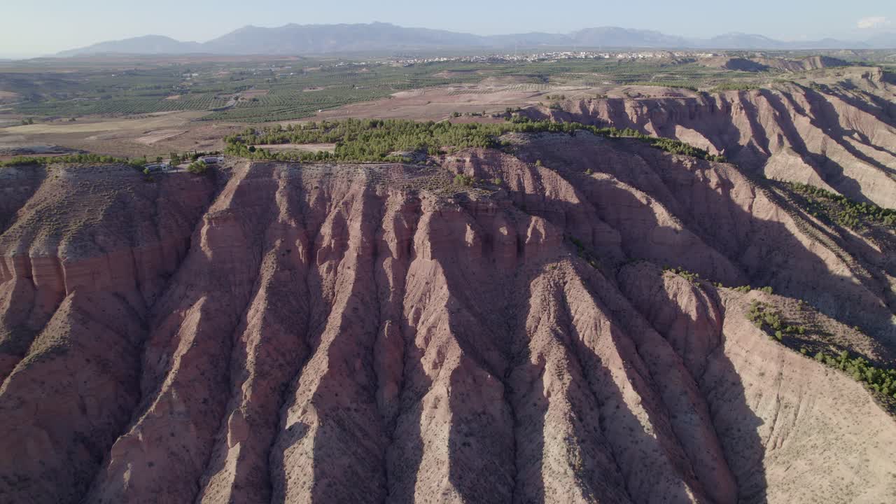Desertification. Eroded mountains with strange shapes. Desert mountains. Badlands. Aerial panoramic view. Gullies, ravines, and gorges. Granada, Spain