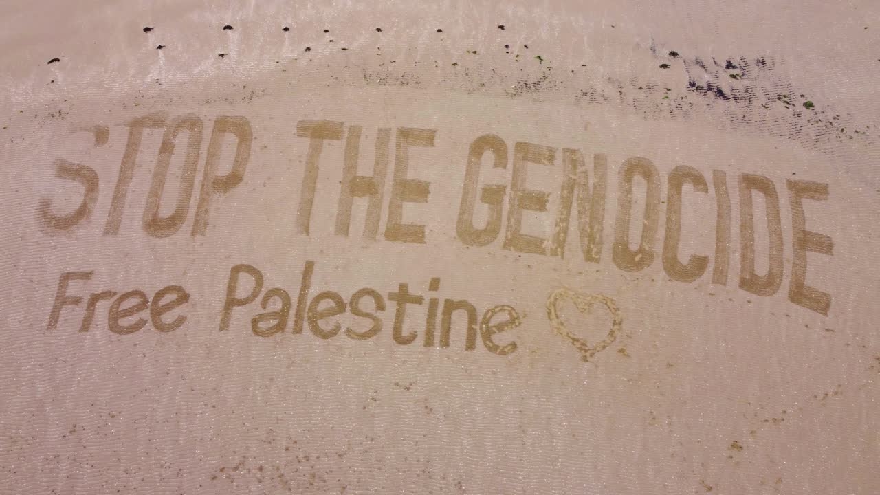 Aerial View of Sand Beach with Protest Slogan About Isreal-Palestine Gaza Conflict in Middle East