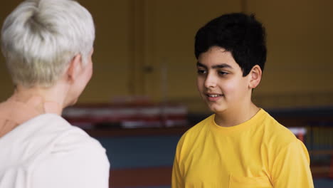 Boy-talking-to-senior-woman-indoors