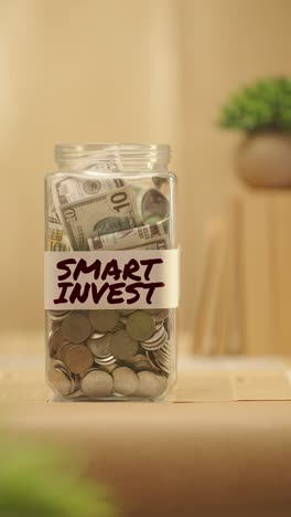 vertical video of person saving money for smart invest