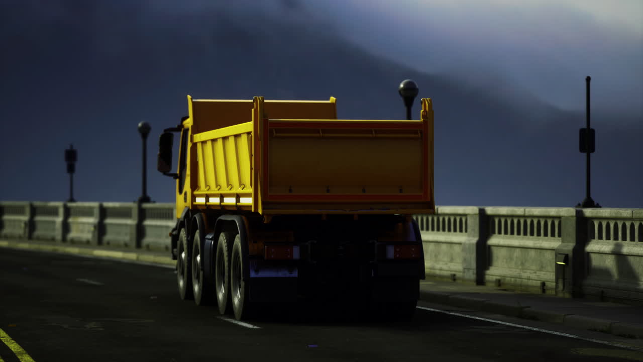 Bright yellow truck stands alone on a foggy road near a bridge
