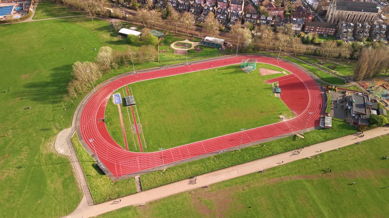 Parliament hill athletic running track aerial view orbits over oval sporting loop landmark in London