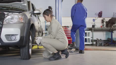 Video-of-caucasian-female-car-mechanic-changing-tyre
