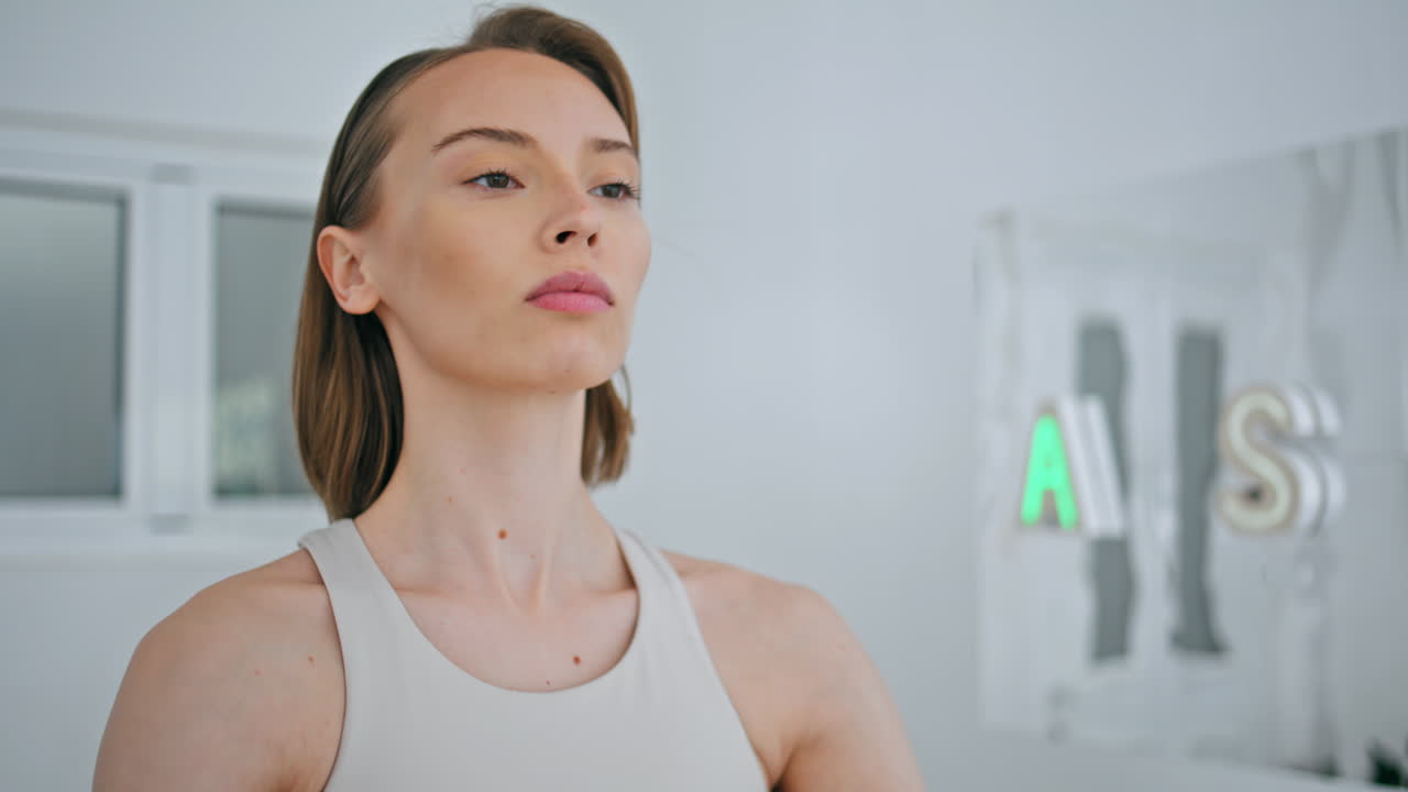 Flexible lady stretches hands using fitness gum home closeup. Fit woman workout