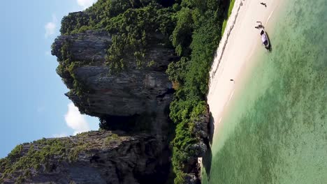 vertical, hidden white sand lagoon and tropical sean on exotic island, pull back aerial revealing view