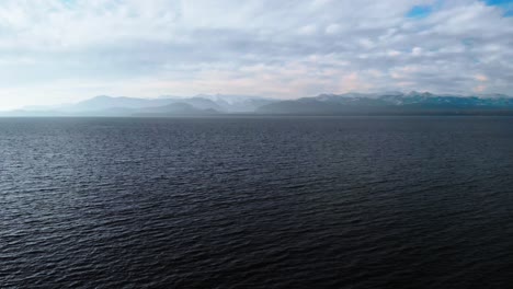 Aerial-shot-of-a-serene-lake-surrounded-by-mountains-in-Patagonia