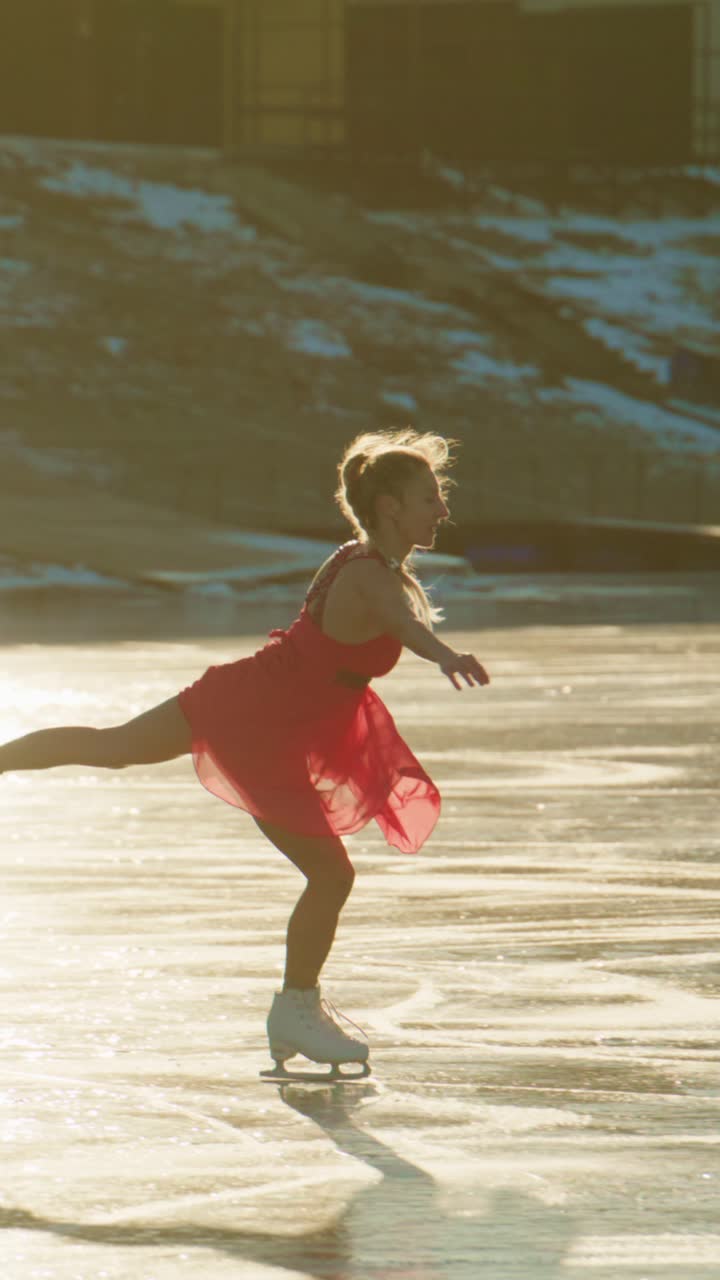 Graceful Figure Skater in a Flowing Red Dress Performing on Ice Amidst a Reflective Surface, Embracing the Joy and Elegance of Winter Sports in an Enchanting Setting