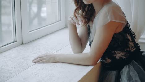 Trendy woman in evening dress. Young model girl dressing evening dress in decorated studio