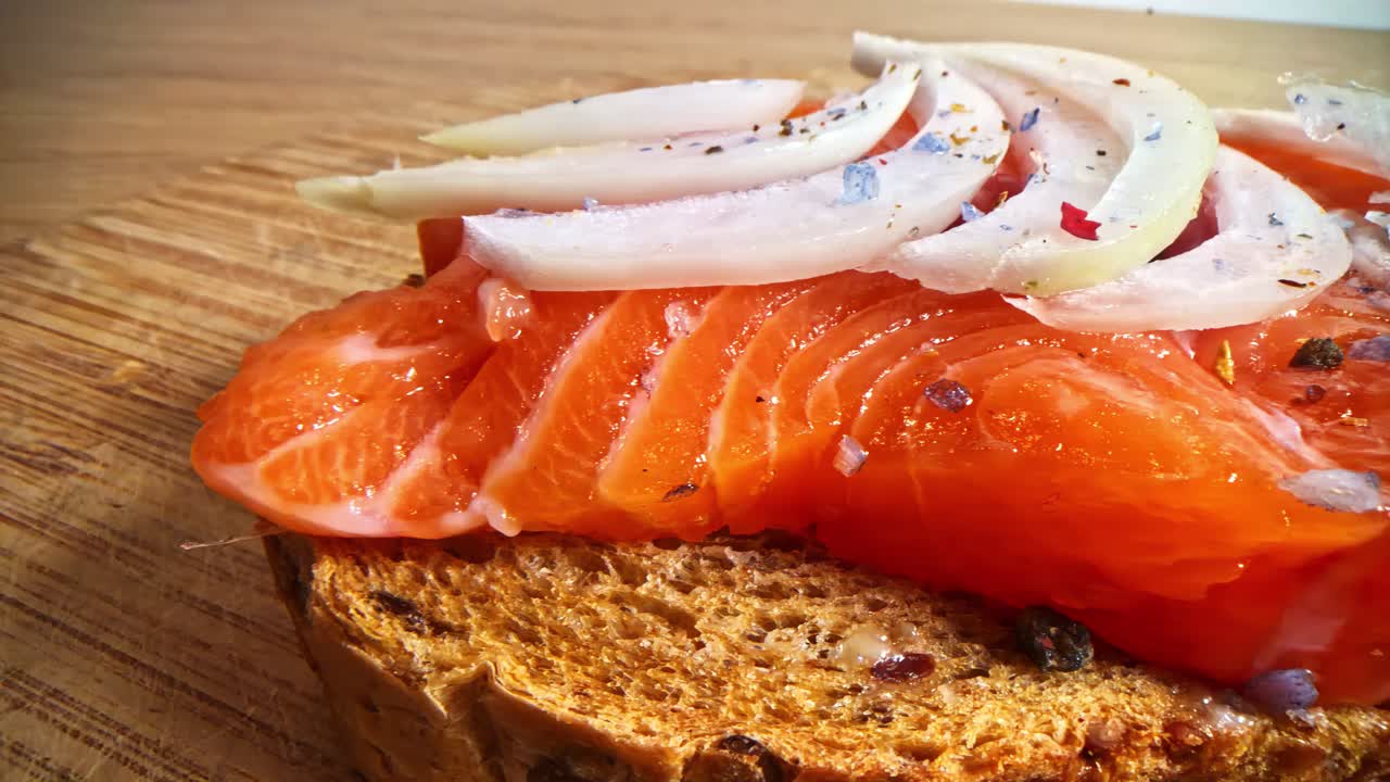 Smoked salmon on toast with sliced onions and seasonings comfort food