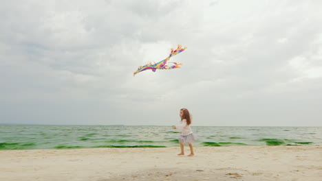 3yo-Girl-Playing-With-A-Kite-On-The-Beach-02