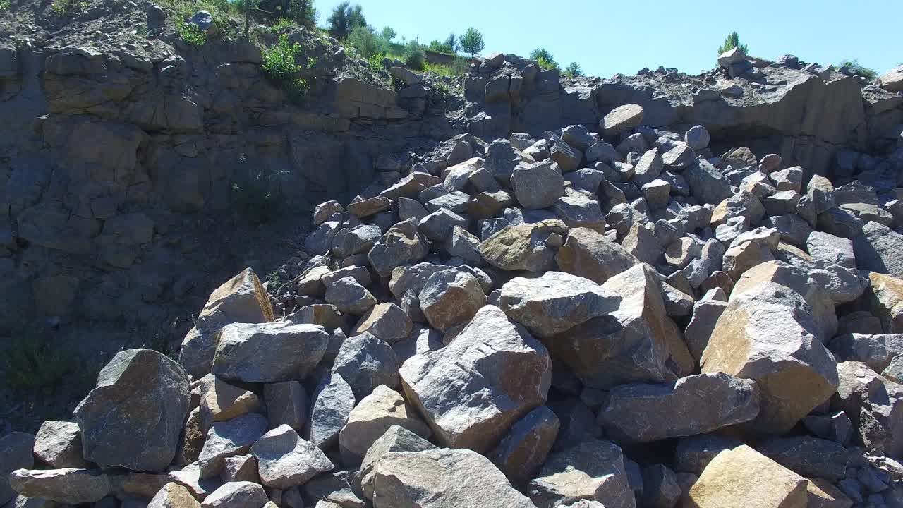 Couple Staying Over Stones. Aerial shot of a bride and groom standing near the large stones. Happy couple