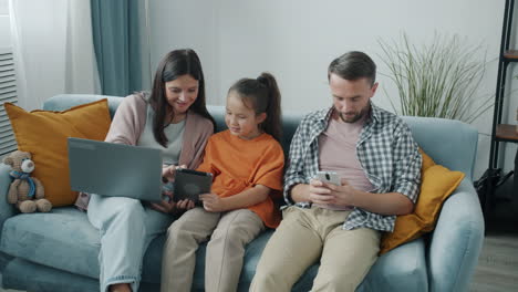 family using digital devices at home