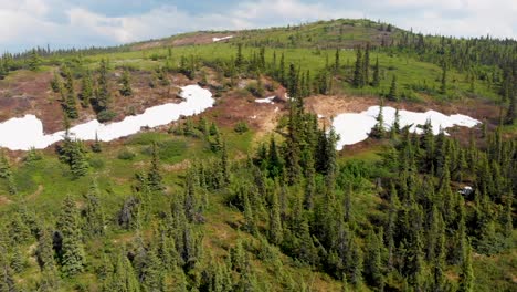 4k drone video of snow patches on wickersham dome in the white mountains of alaska on sunny summer day