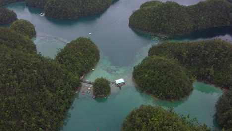 aerial, floating pontoon-style house of sugba lagoon in siargao island, philippines