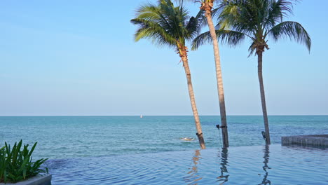 majestic view on tropical sea horizon from poolside of infinity pool of luxury hotel resort, static shot with copy space