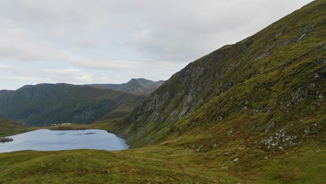 aerial over the rugged hills and lakes near vanylven municipality, norway