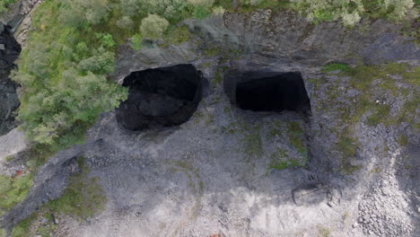 Aerial view of abandoned lime mines in the Norwegian mountains, with rocky cliffs and remnants of old industry in a dramatic Nordic landscape