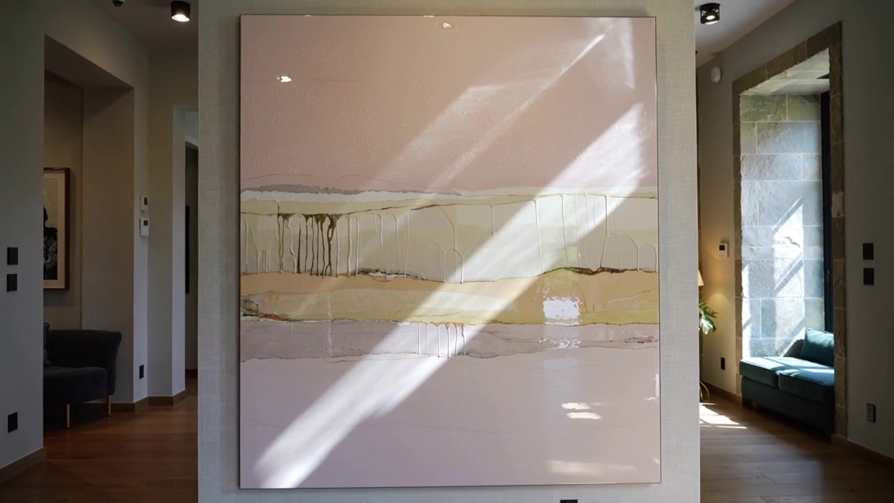 Gliding sunlight from right window casting diagonal on painting, view pulling back showing entryway